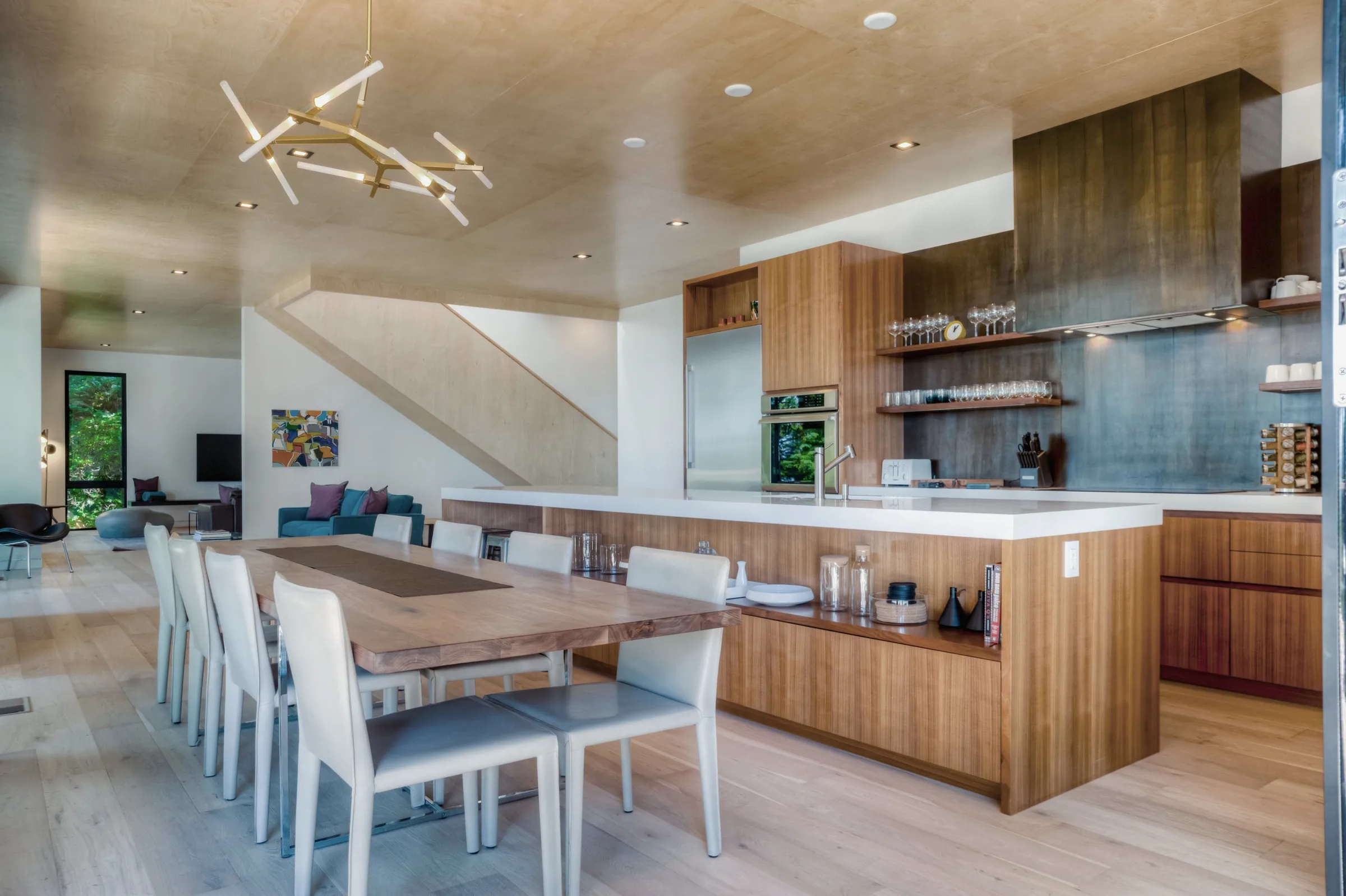 Open kitchen and dining room with walnut cabinetry, a long island and a timber dining table — furniture and millwork designed and built by Jack Rusk (Oakland and Los Angeles, 2013–2018)