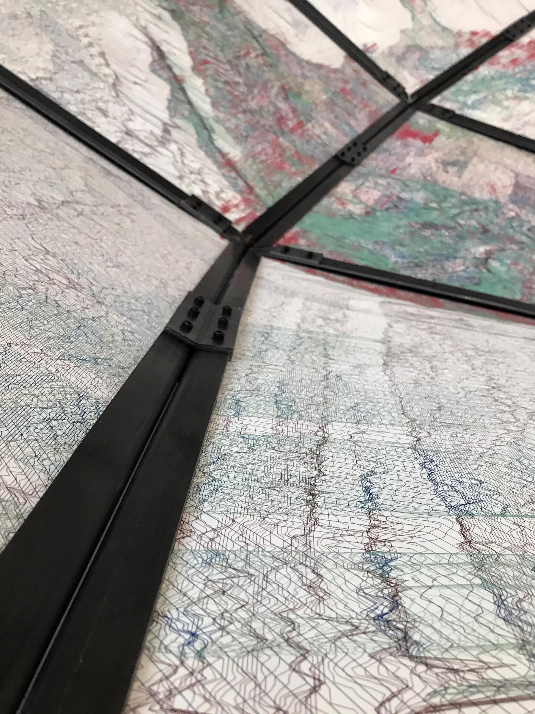 Close-up of a black steel bracket joining translucent hand-drawn map panels — detail of 'The World Turned Inside Out', fabricated by Jack Rusk with Adare Brown, Christopher Cambio and Tyler Krebs for the 2021 Venice Biennale