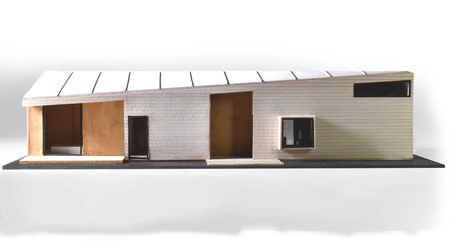 Photo of a half-inch scale building model with a sloped roof, timber cladding and deep window openings — from Transitional Housing, a two-unit dwelling by Jack Rusk and collaborators (Yale School of Architecture, Spring 2020)